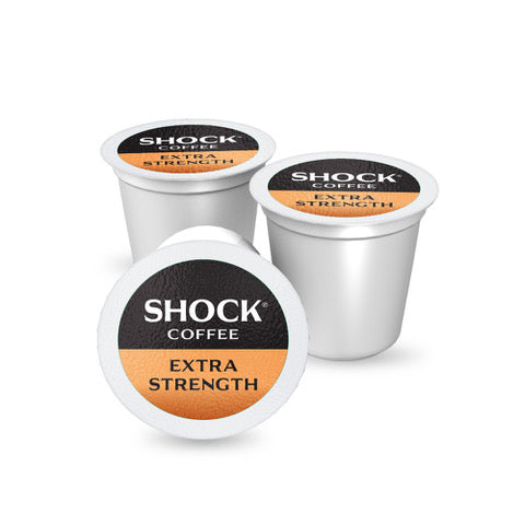 Three white coffee pods with 'Shock Coffee Extra Strength' label on a white background